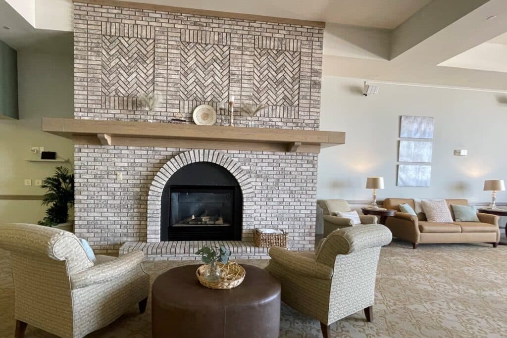 living room in a senior community featuring a warm fireplace